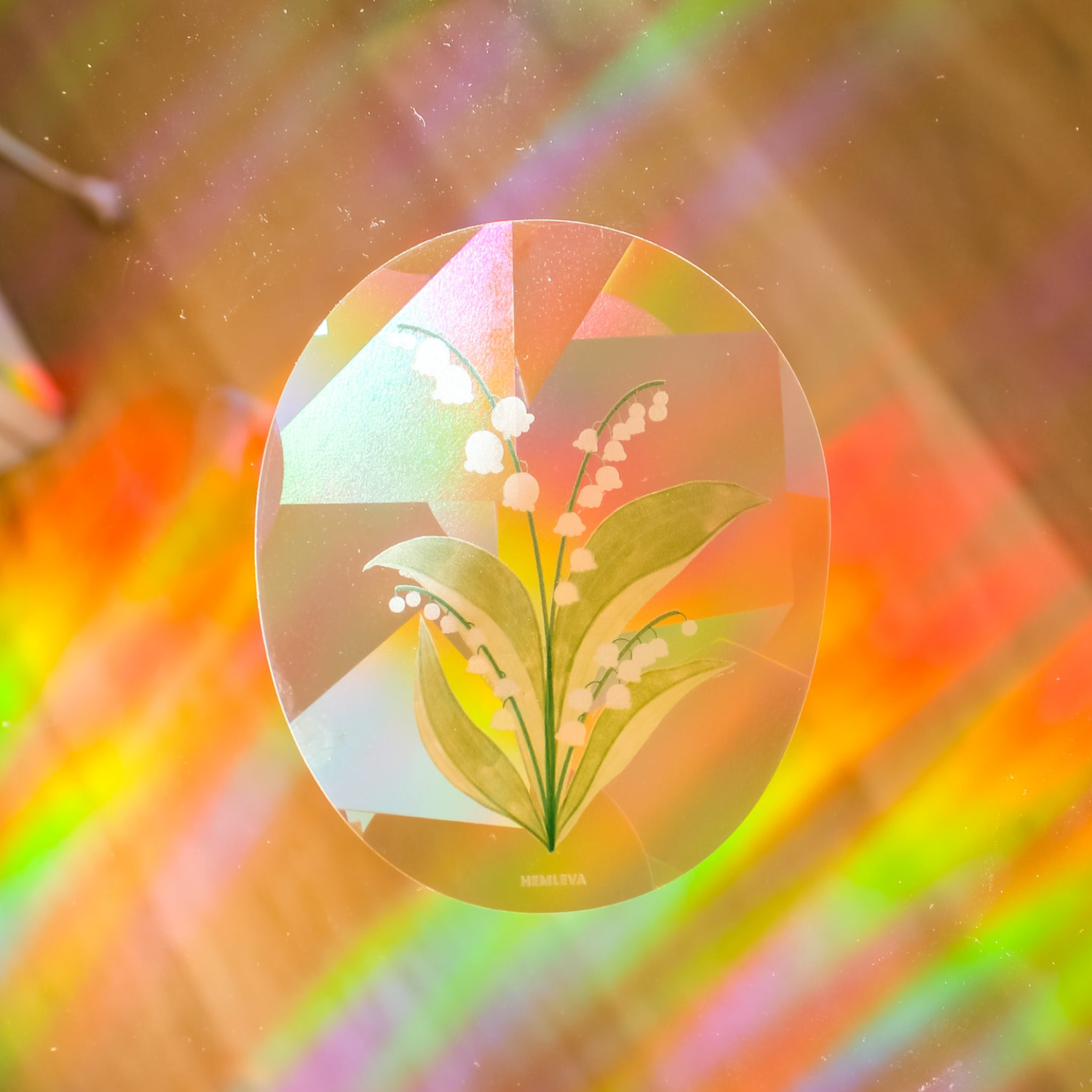 Medium circular suncatcher with lily of the valley flowers and green leaves illustration