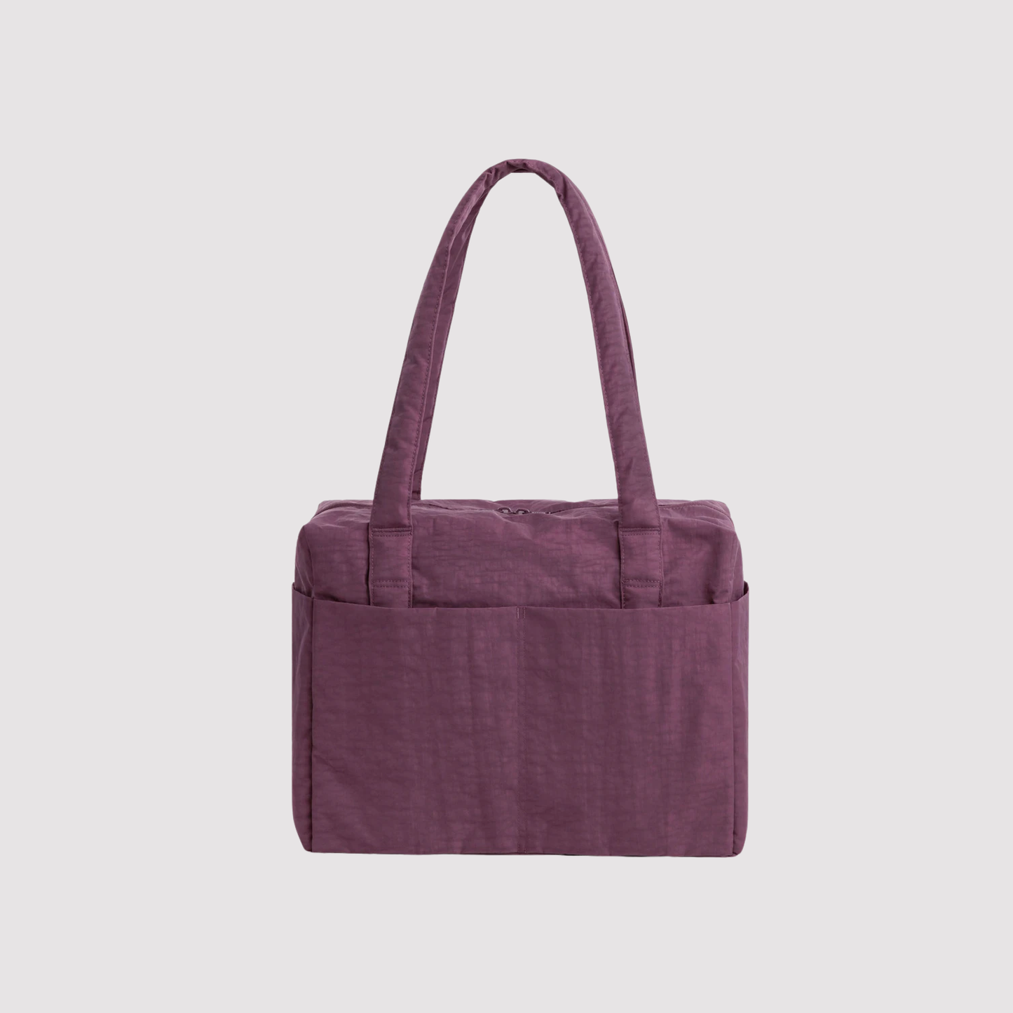 Purple foldable travel tote bag with wide top handles and front pocket detail.