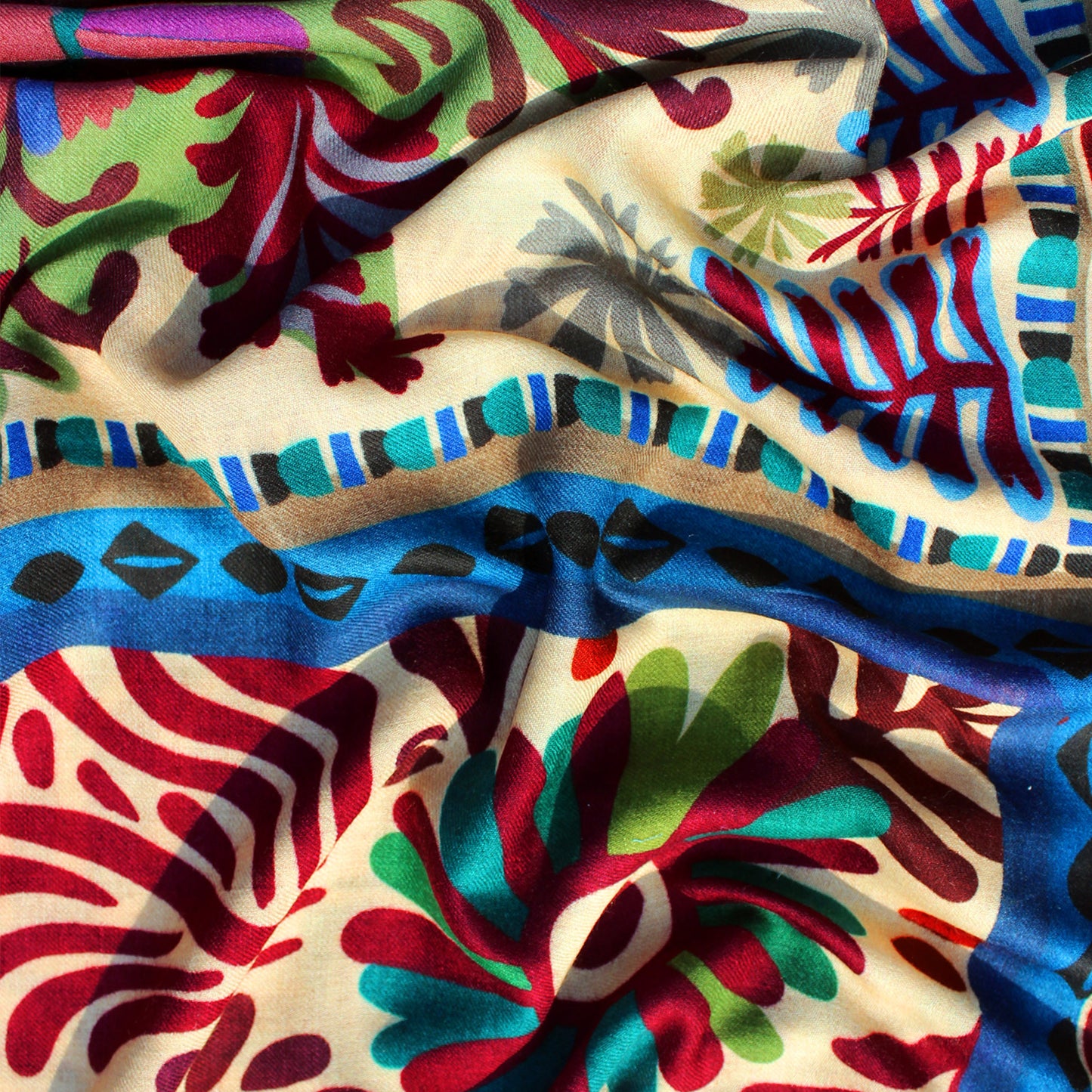 Kantha scarf fabric close-up with multicolor botanical prints and wavy blue stripes