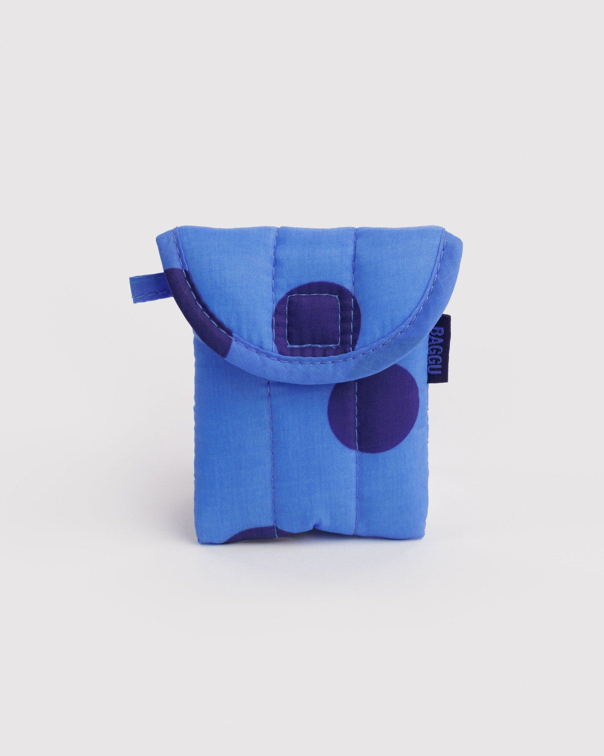 Blue puffy earbuds case with dark purple circular patch and quilted flap, black label tag