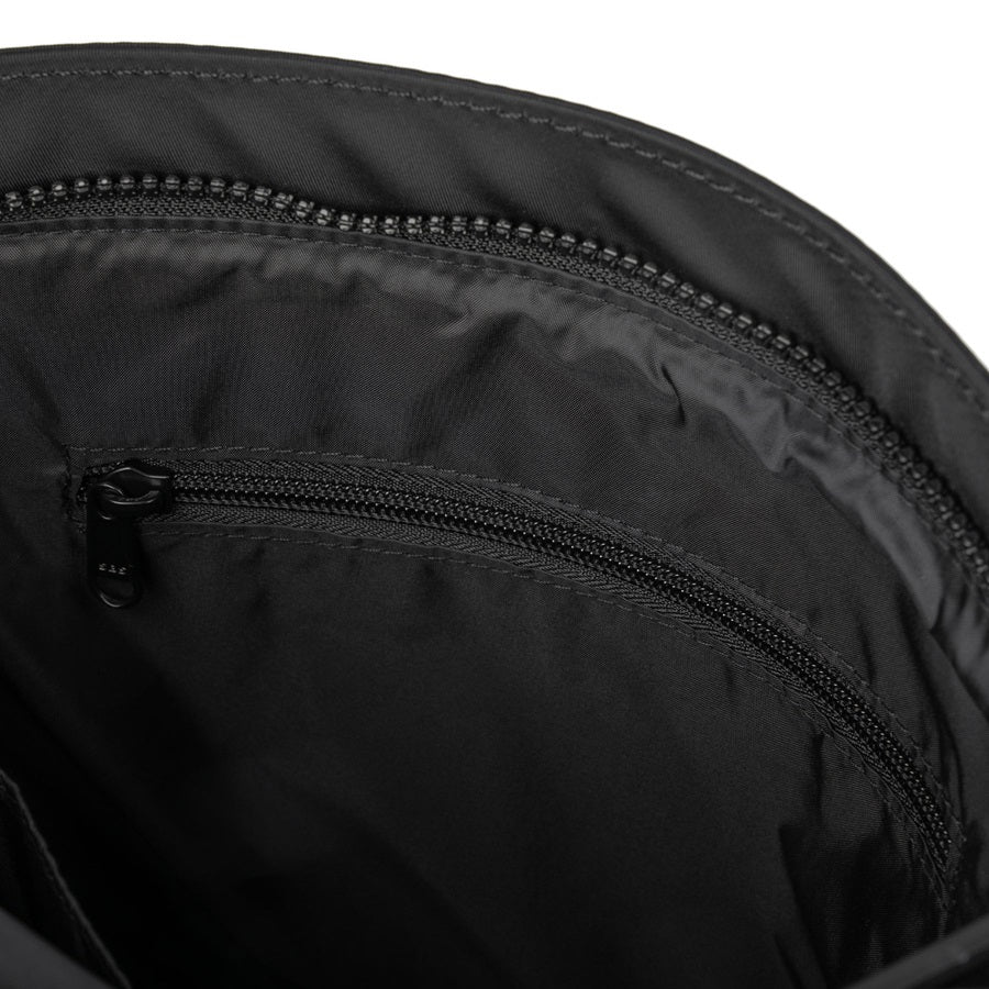 Interior view of black nylon crossbody bag with zip pocket and zipper hardware