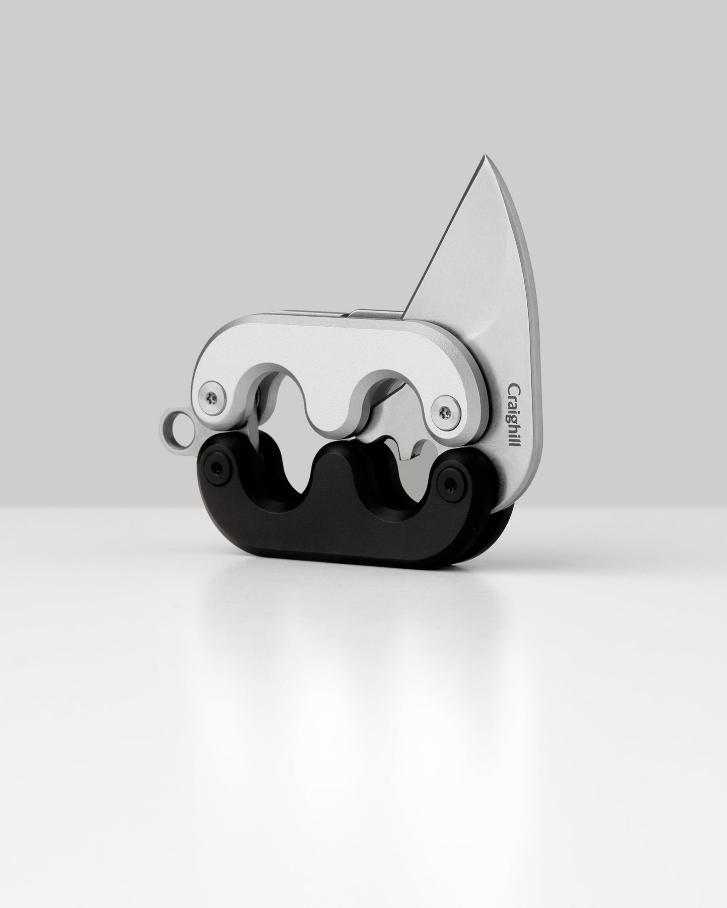 Mini folding knife with angled blade open, silver frame and black handle