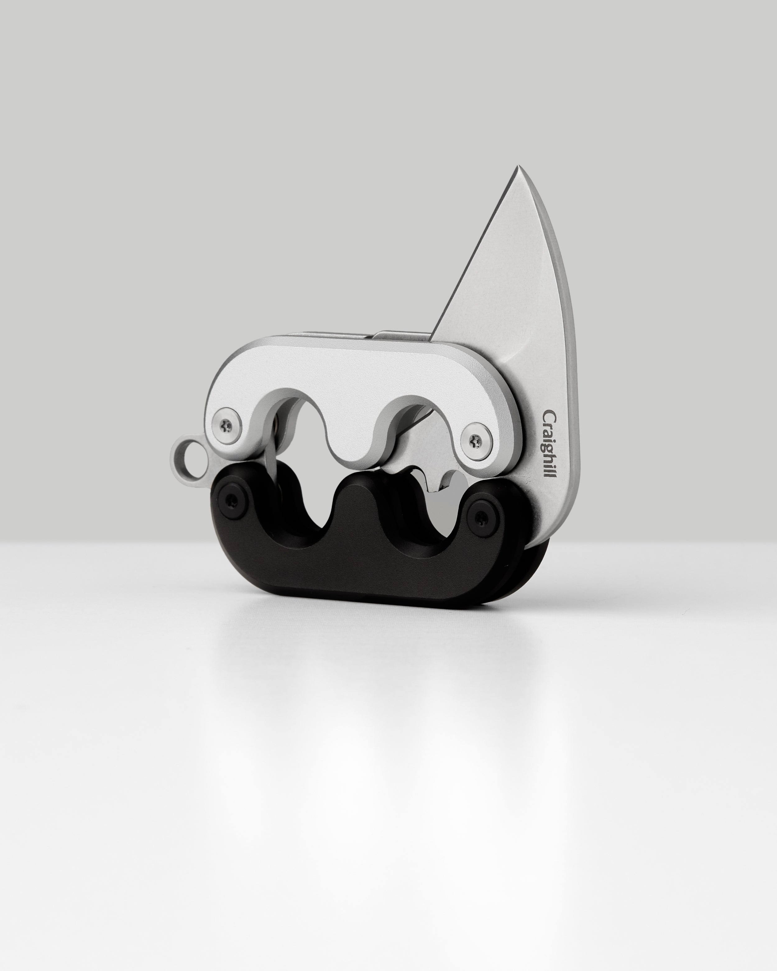 Mini folding knife with angled blade open, silver frame and black handle
