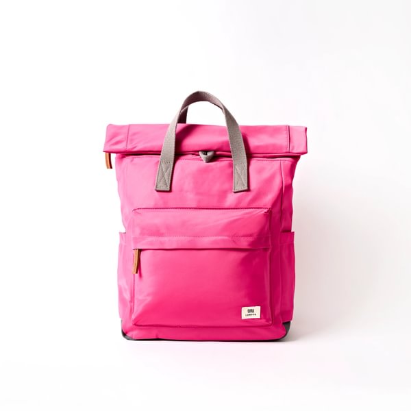 Medium nylon backpack, bright pink with front flap pocket and top handles.