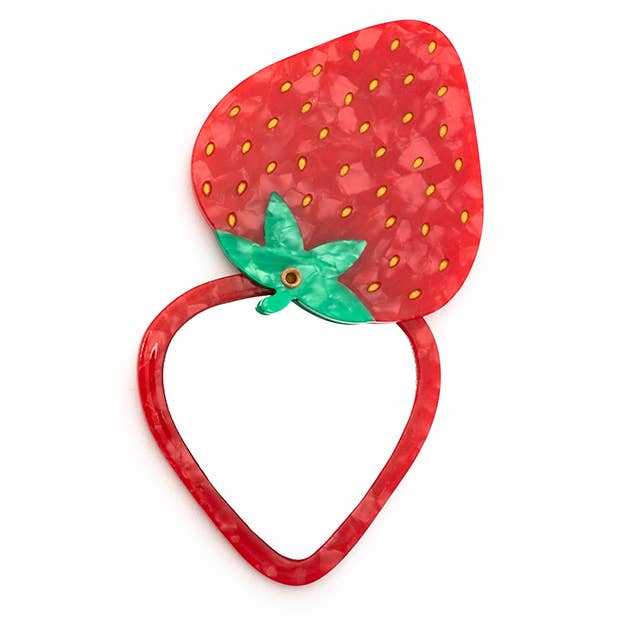 Folding compact mirror shaped like a red strawberry with green leaf, dotted seeds, open