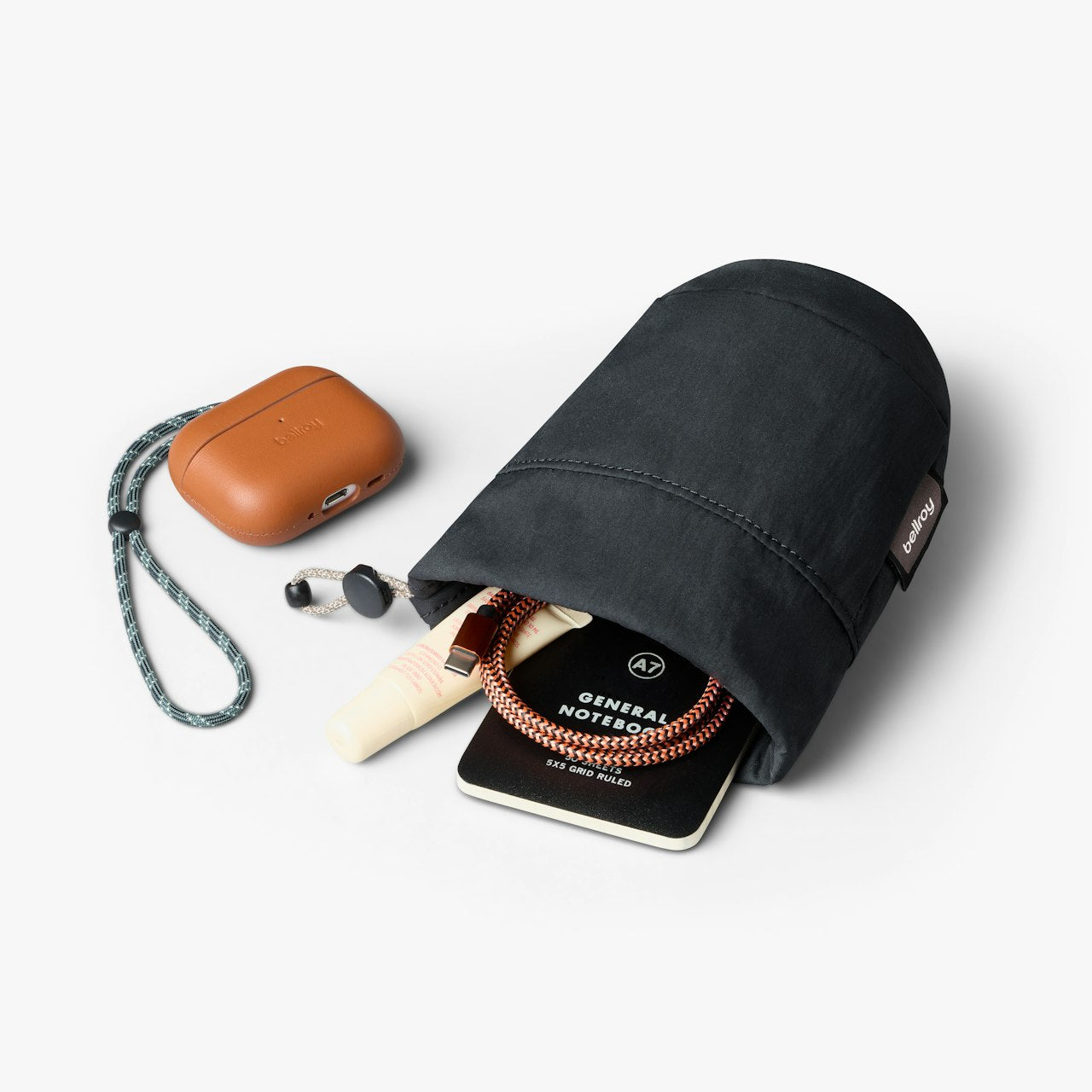 Black cinch pouch with carabiner clip and braided rope drawcord, with small accessories
