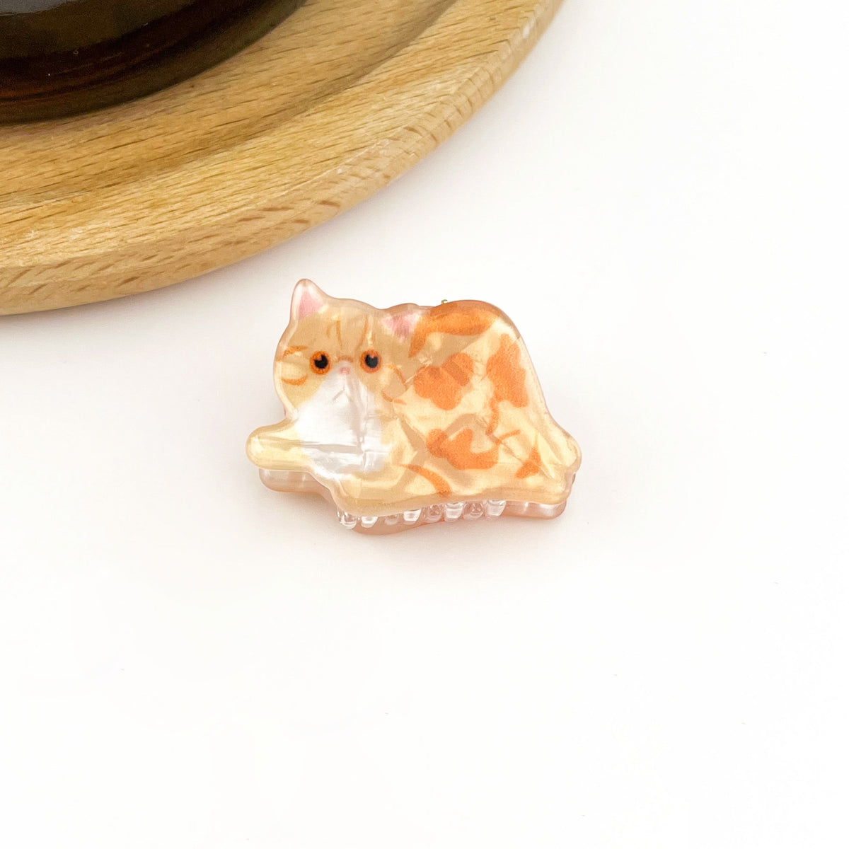 Orange cat mini hair claw with cartoon cat face, glossy translucent finish
