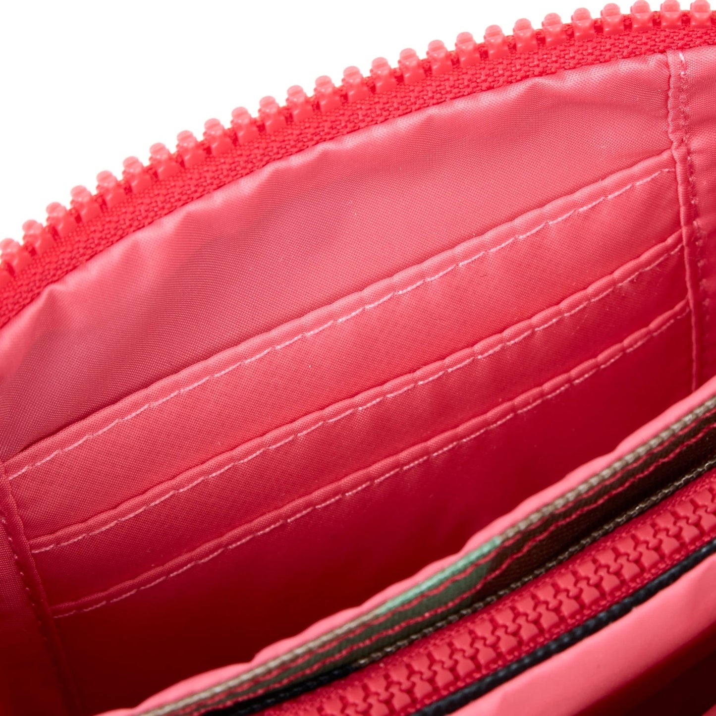 Medium recycled canvas zipper pouch with red interior lining and close-up zipper teeth.