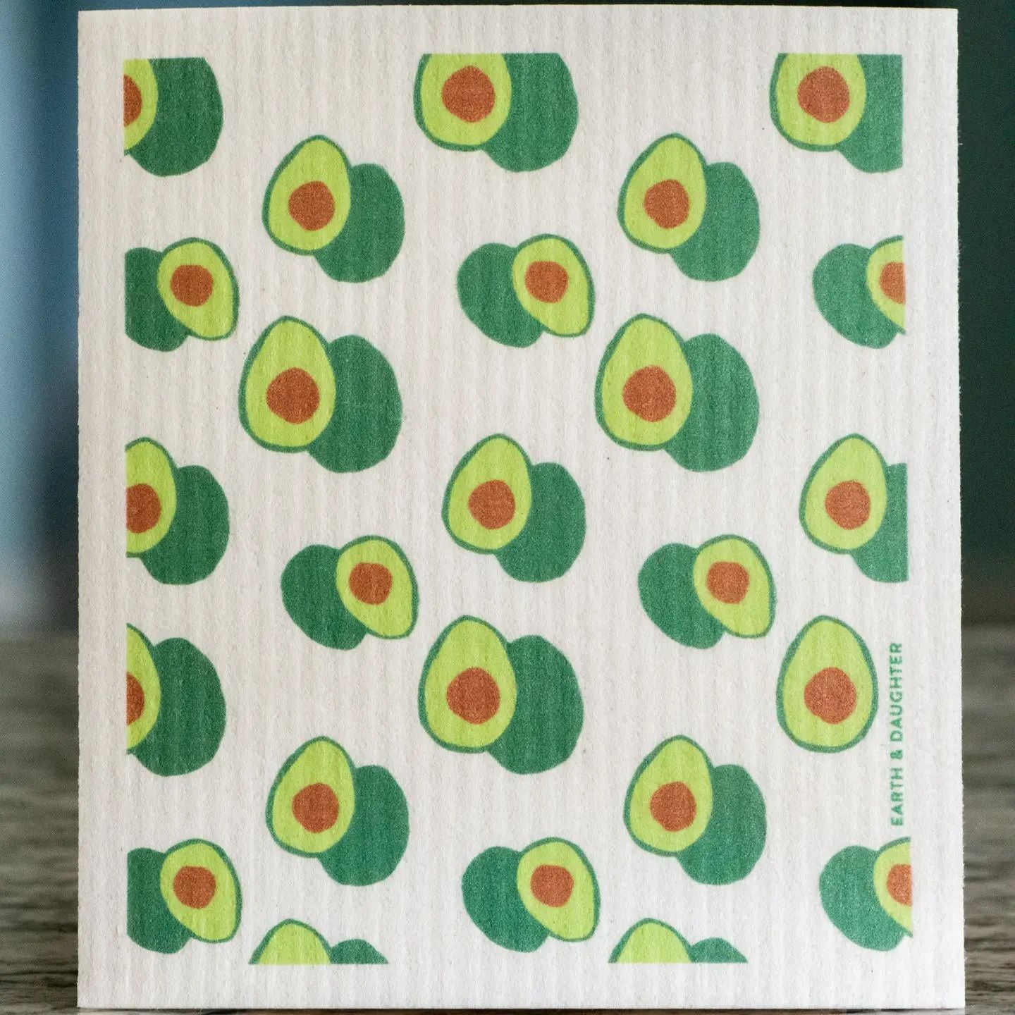 Dish washing sponge cloth with repeating green avocado print on a white fabric base