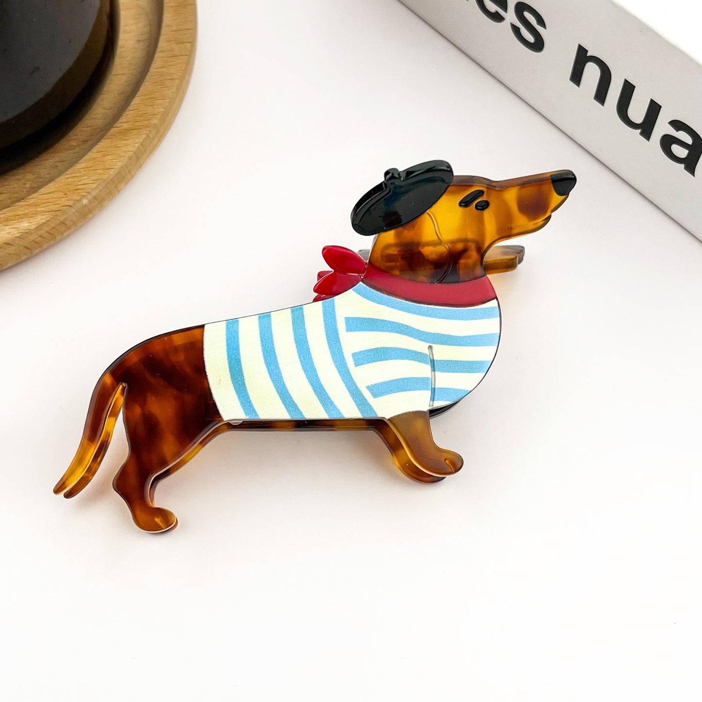 Dog-shaped hair claw clip with blue-and-white striped sweater and red bow detail