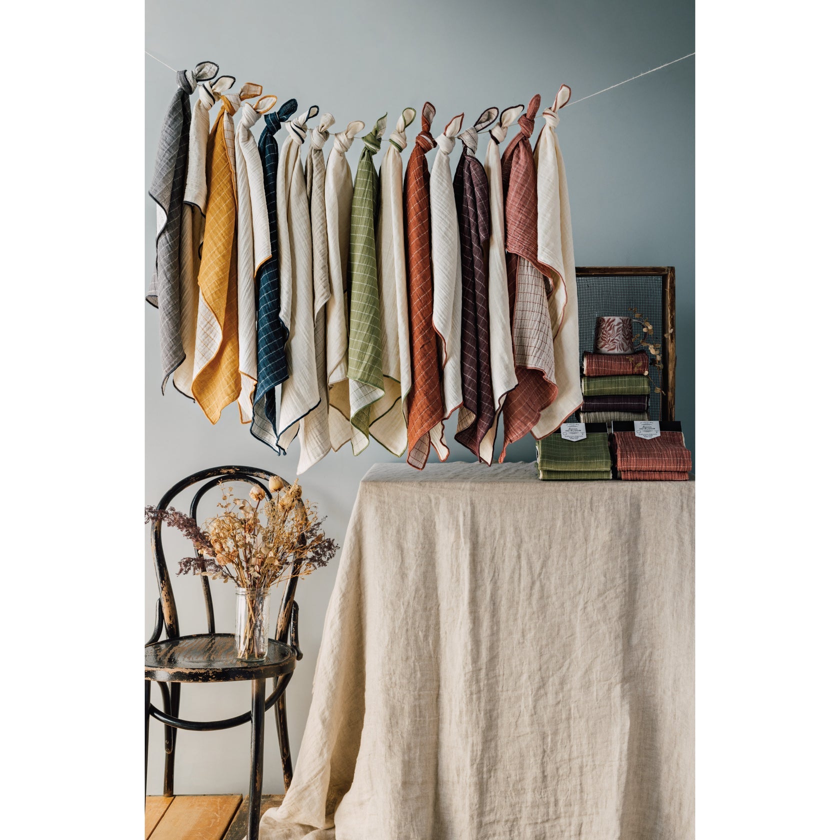 Double-weave dishtowels displayed on hooks, assorted neutral and warm colors.