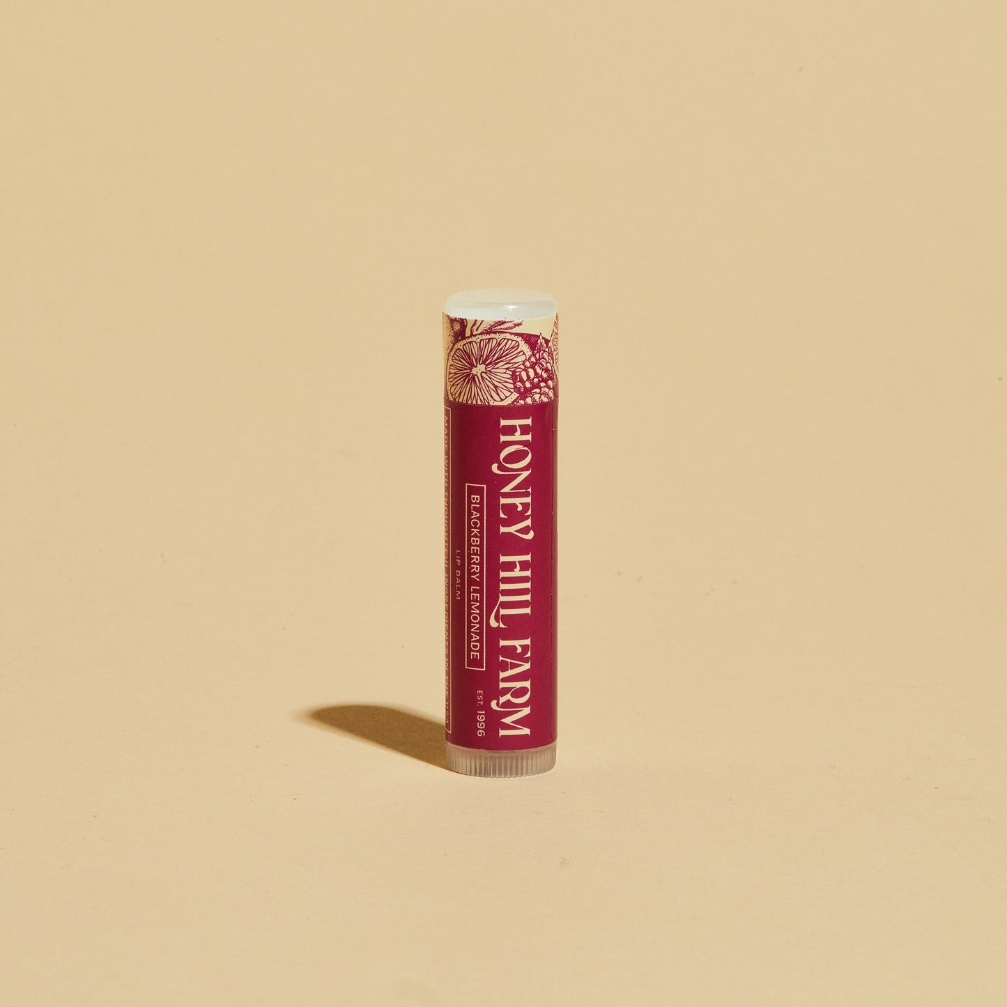 Lip balm tube with red label and white cap