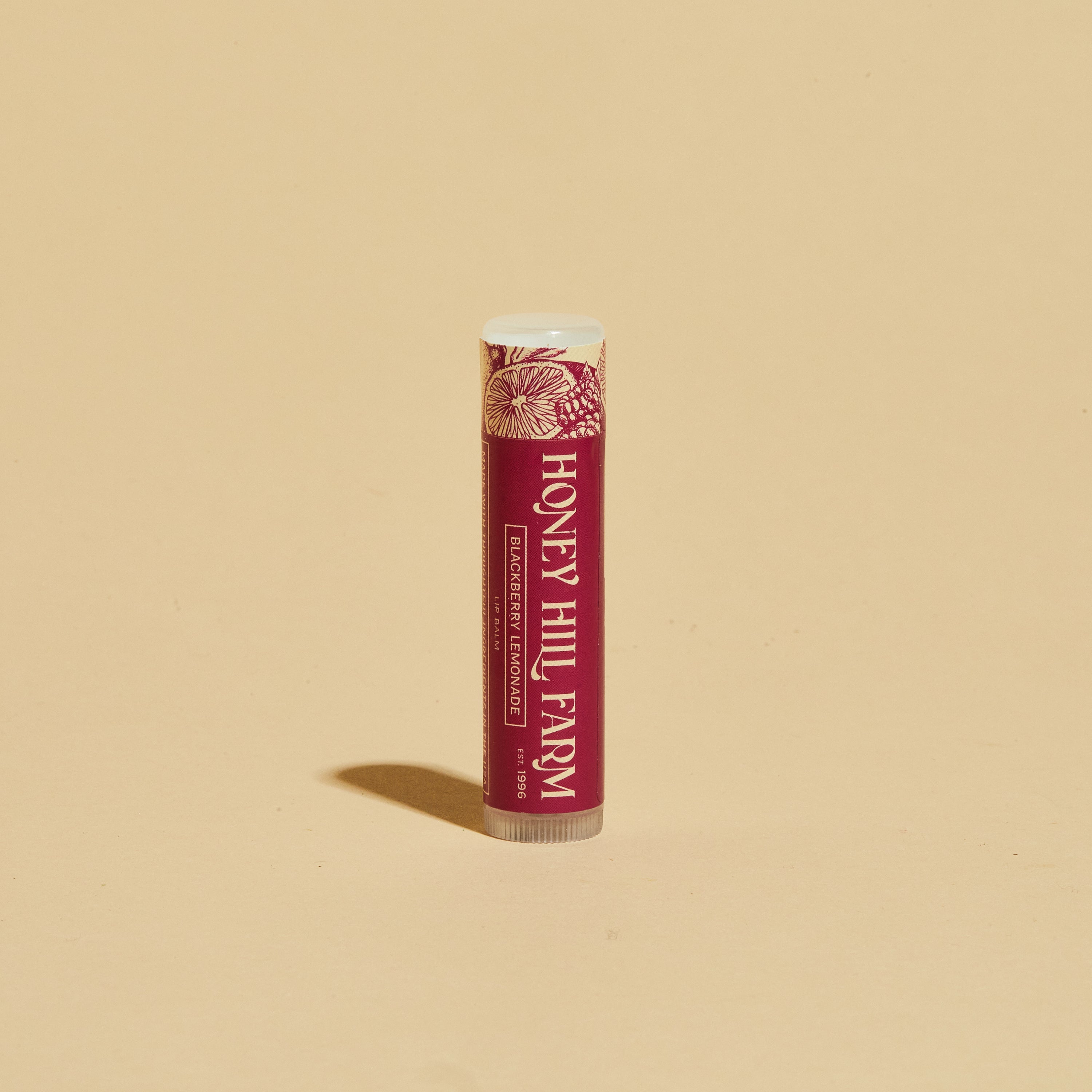 Lip balm tube with red label and white cap