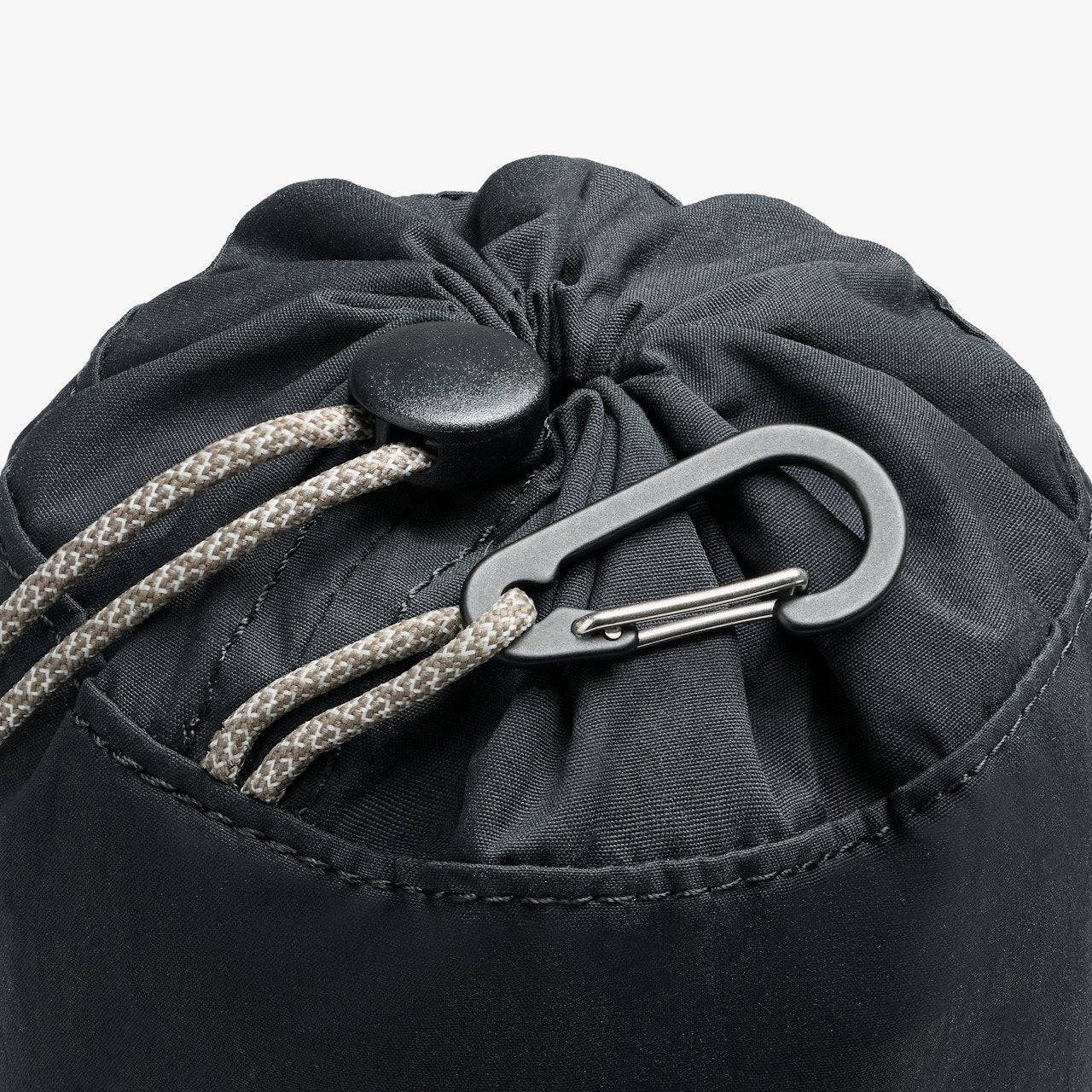 Black cinch pouch close-up: gathered top with braided drawcord and carabiner clip