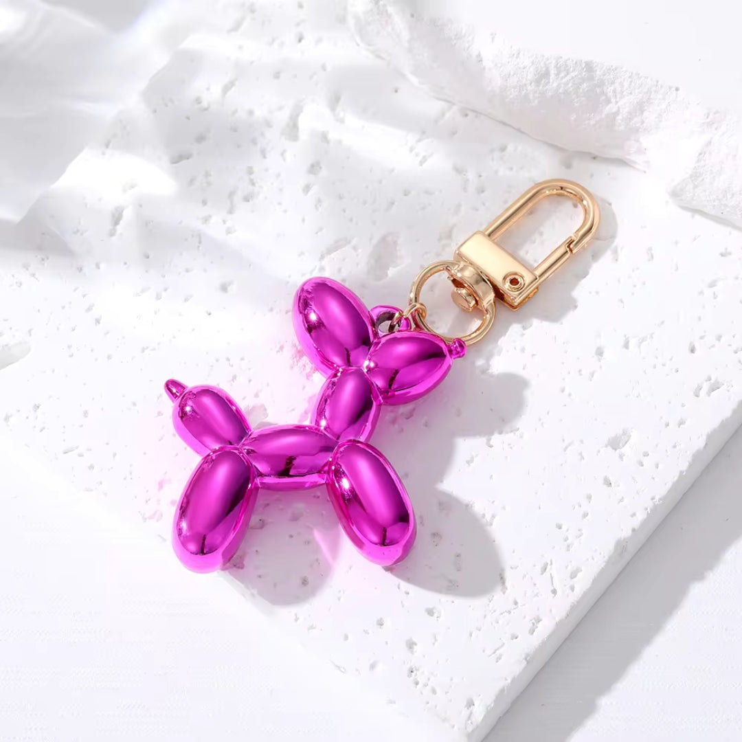 Purple metallic balloon dog keychain with gold clasp and split-ring attachment
