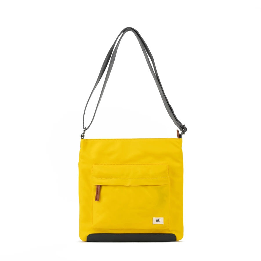 Sustainable nylon crossbody bag in mustard yellow with zip front pocket