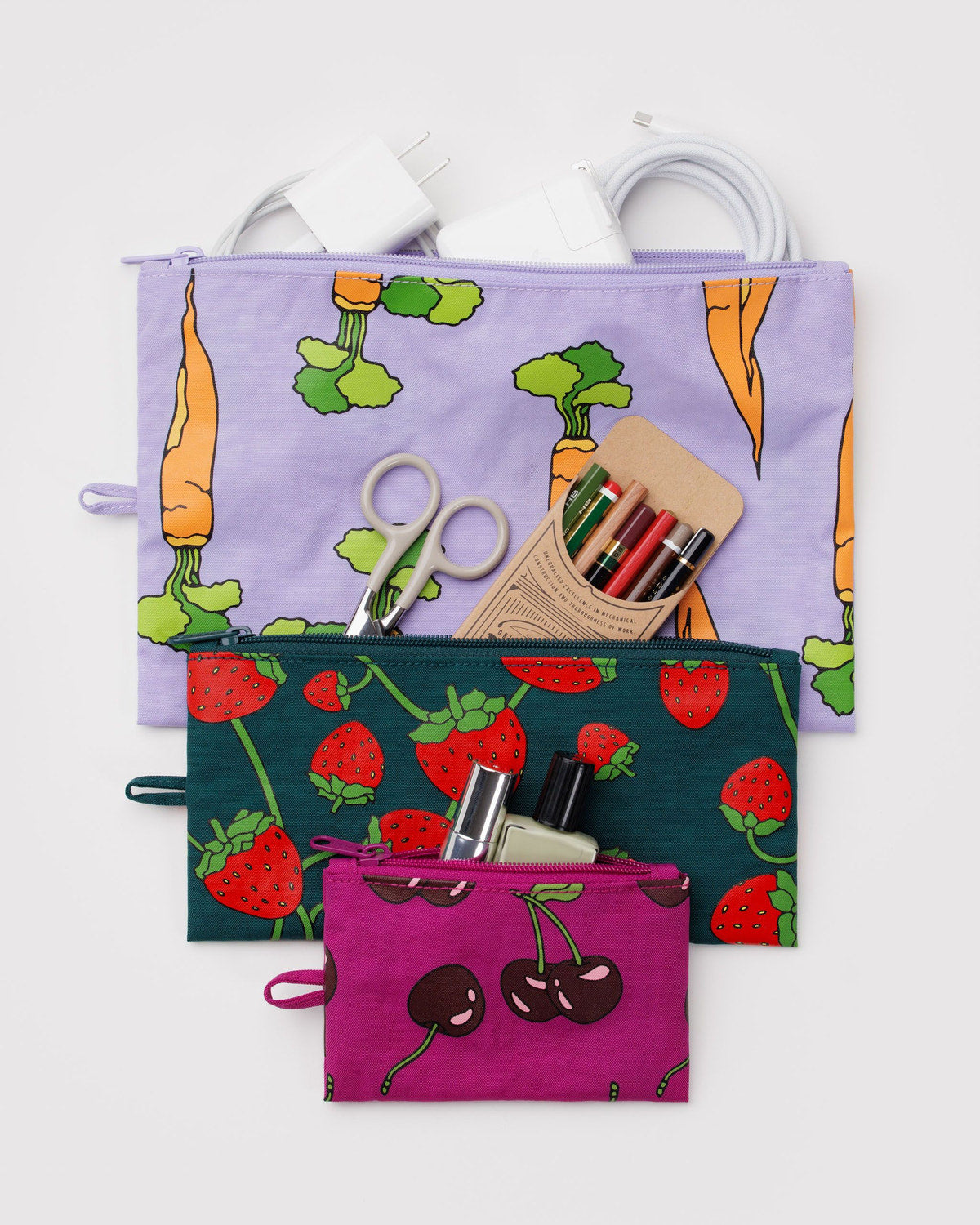 Set of three flat zipper pouches with carrot, strawberry, and cherry prints in bright colors
