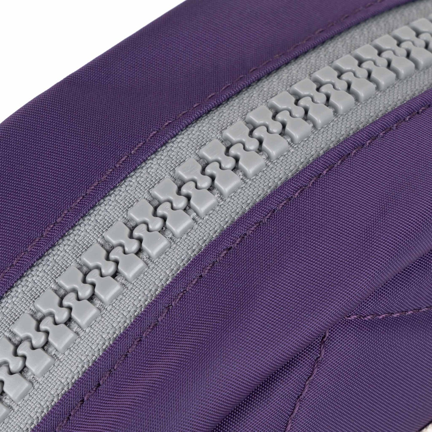 Recycled canvas crossbody bag close-up, purple zipper track with gray teeth