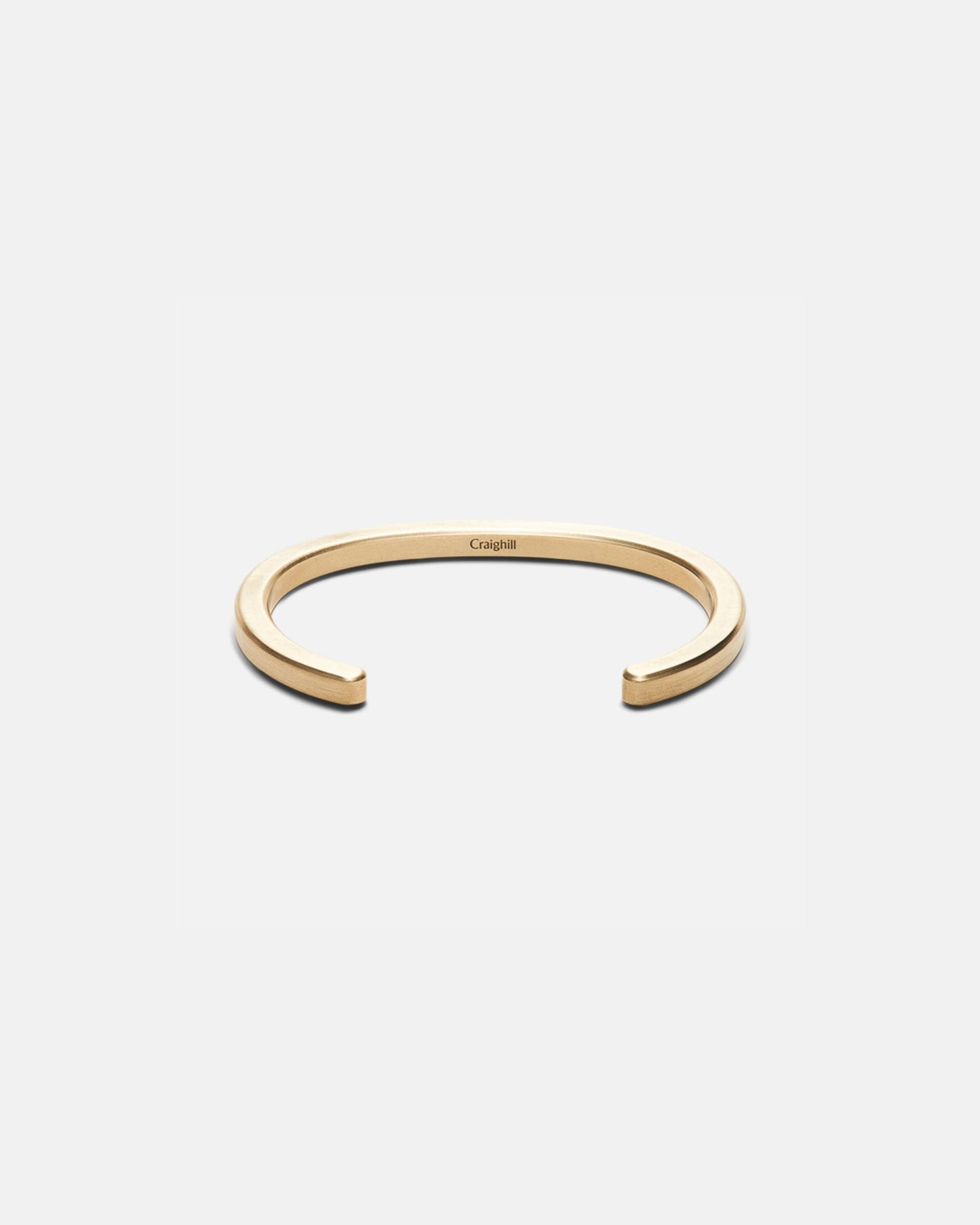 Brass cuff bracelet with open C-shape and radial cutout design