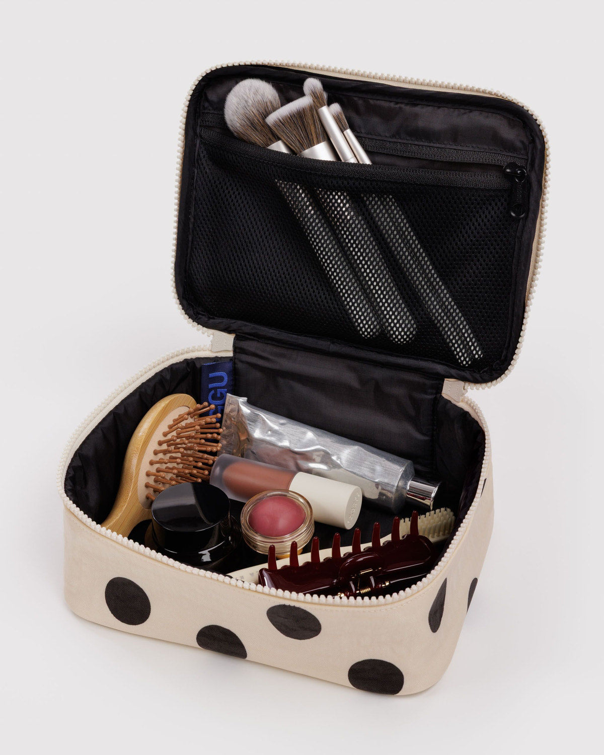 Small cosmetic case, cream polka dot with open lid showing brushes and inner mesh pocket
