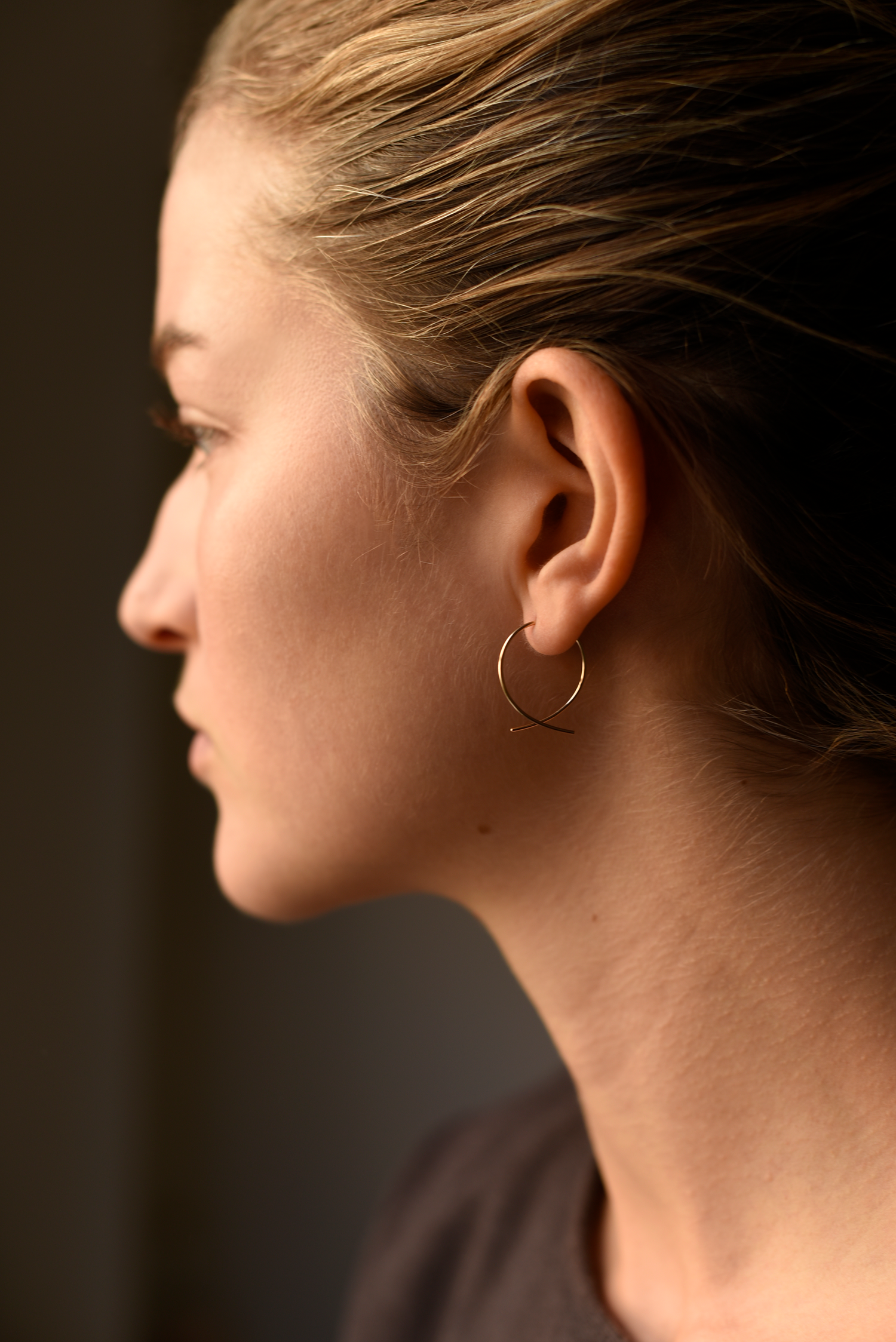 Medium round threader hoop earring worn on ear, gold-tone