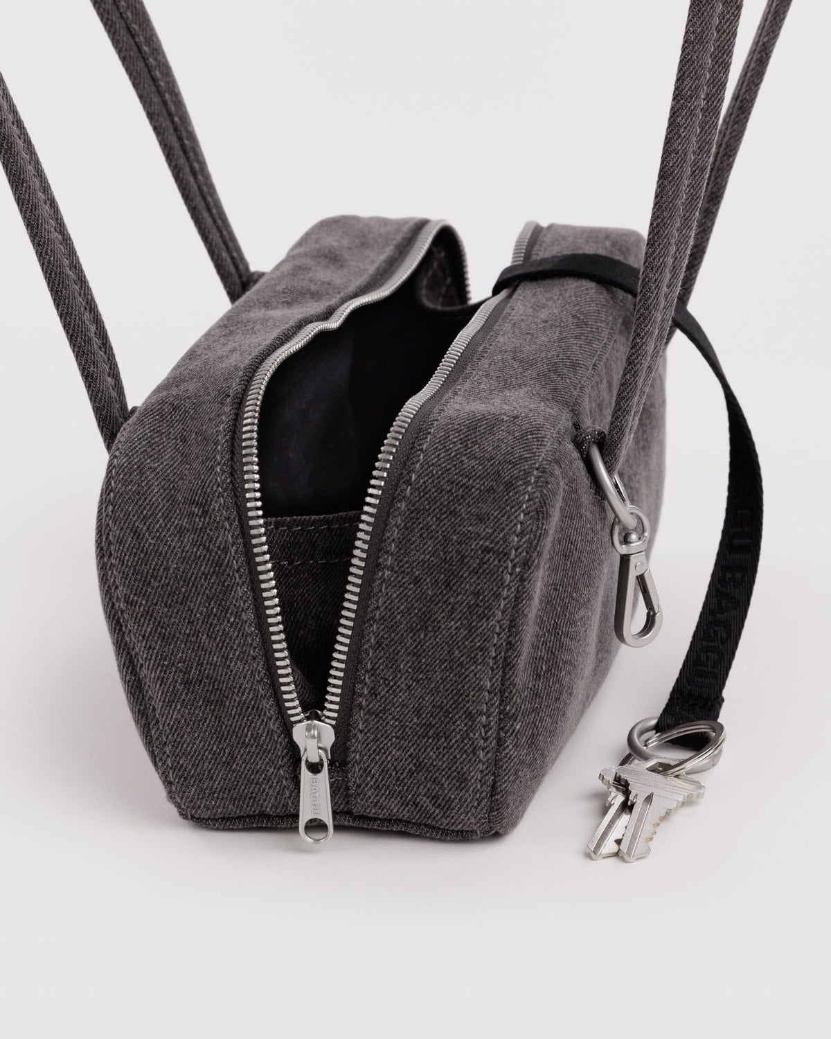 Washed black denim bowler bag with open top, zip closure, and keyring