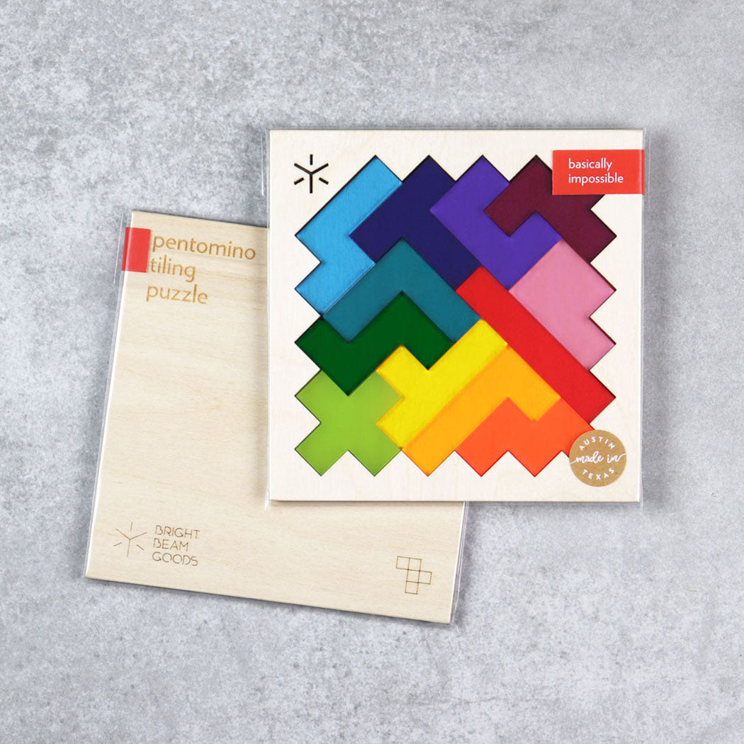 Square pentomino puzzle with rainbow-colored pieces in boxed packaging
