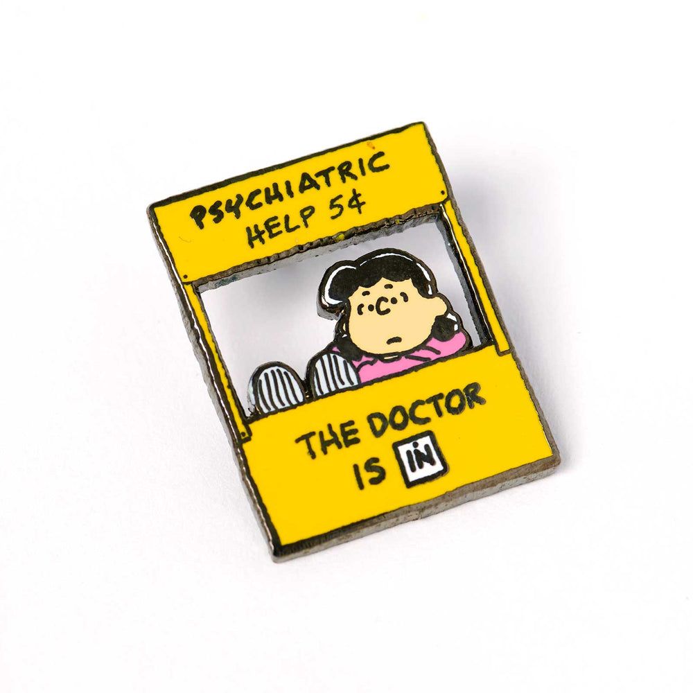 Yellow square enamel pin with cartoon nurse and “Psychiatric Help & The Doctor is In” text