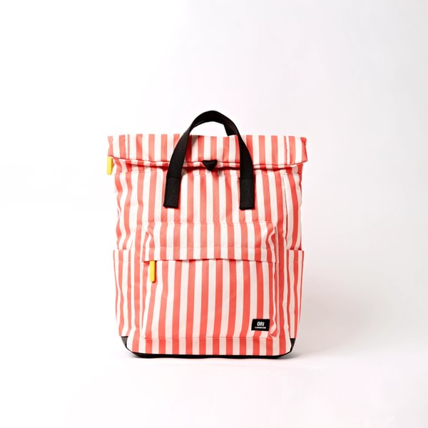 Medium canvas backpack with coral-white vertical stripes, top flap, black webbing handles