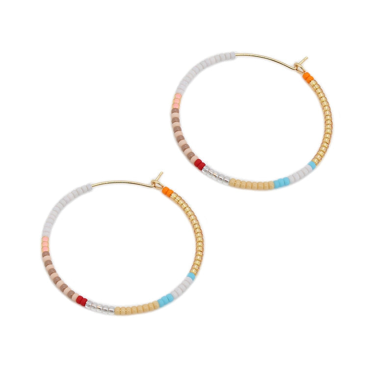 Beaded hoop earrings with gold hooks, light gray and tan beads, red/orange/blue accents