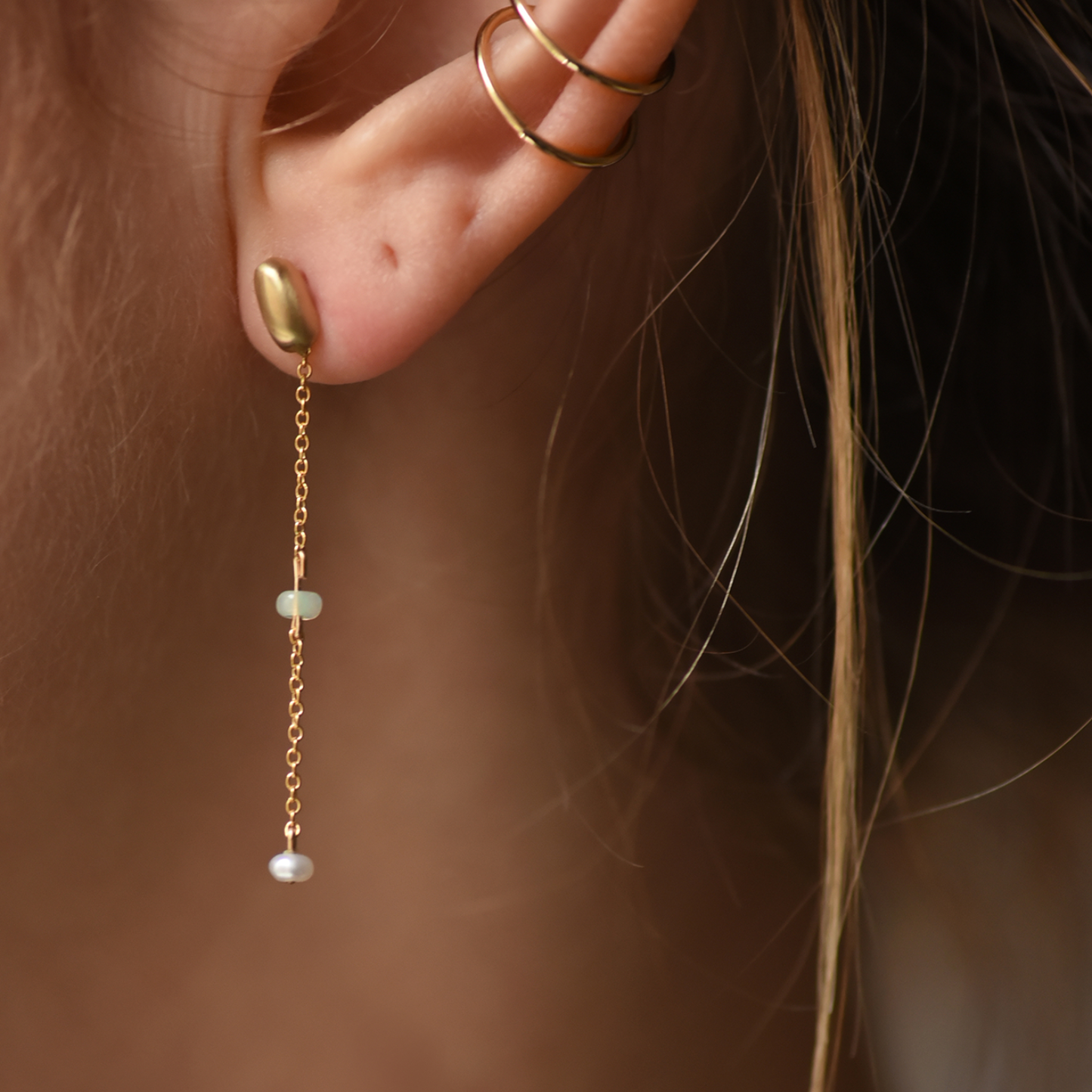 Gold-tone chain drop earrings with green opal center and pearl dangles