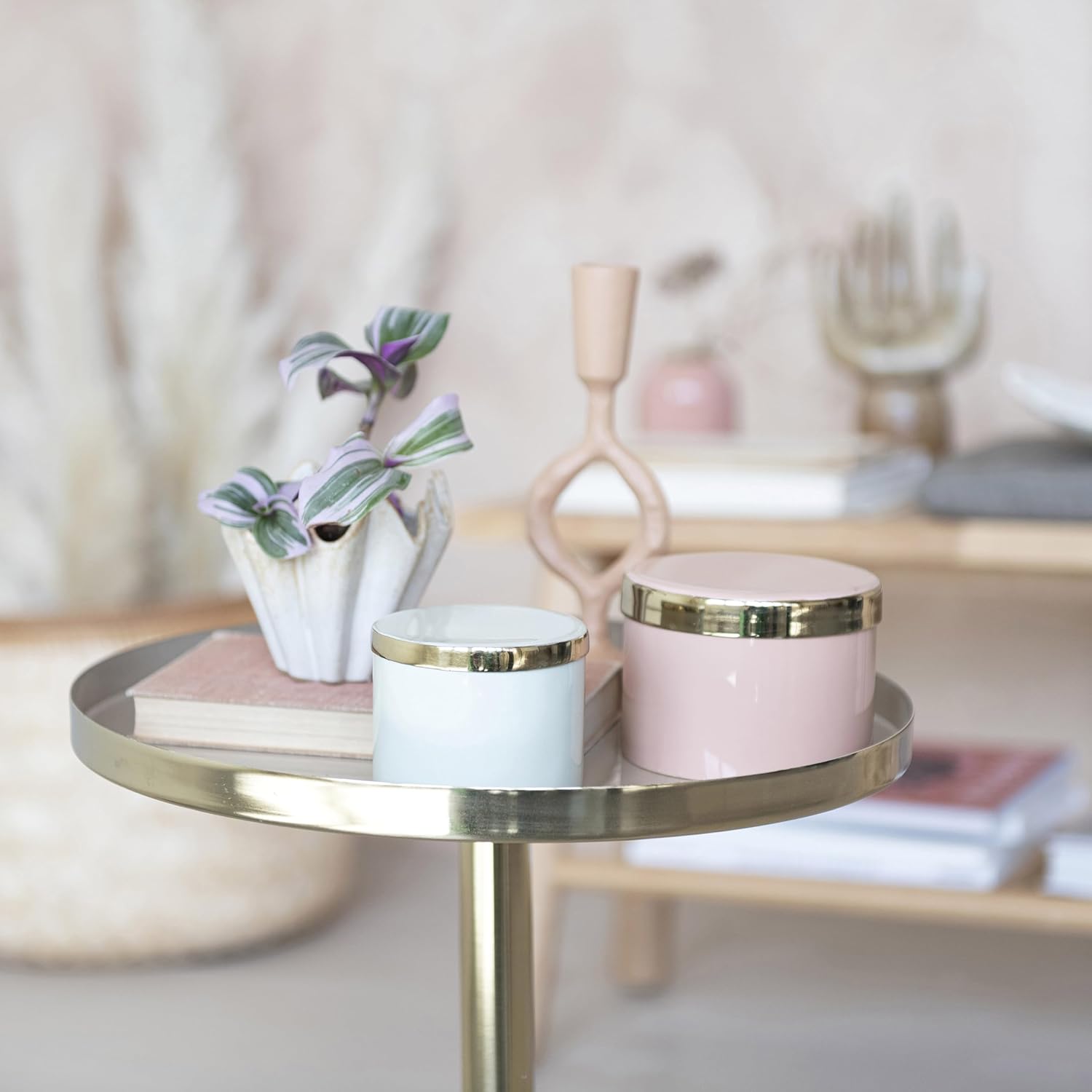 Pink round enamel metal box on gold tray with reflective lid