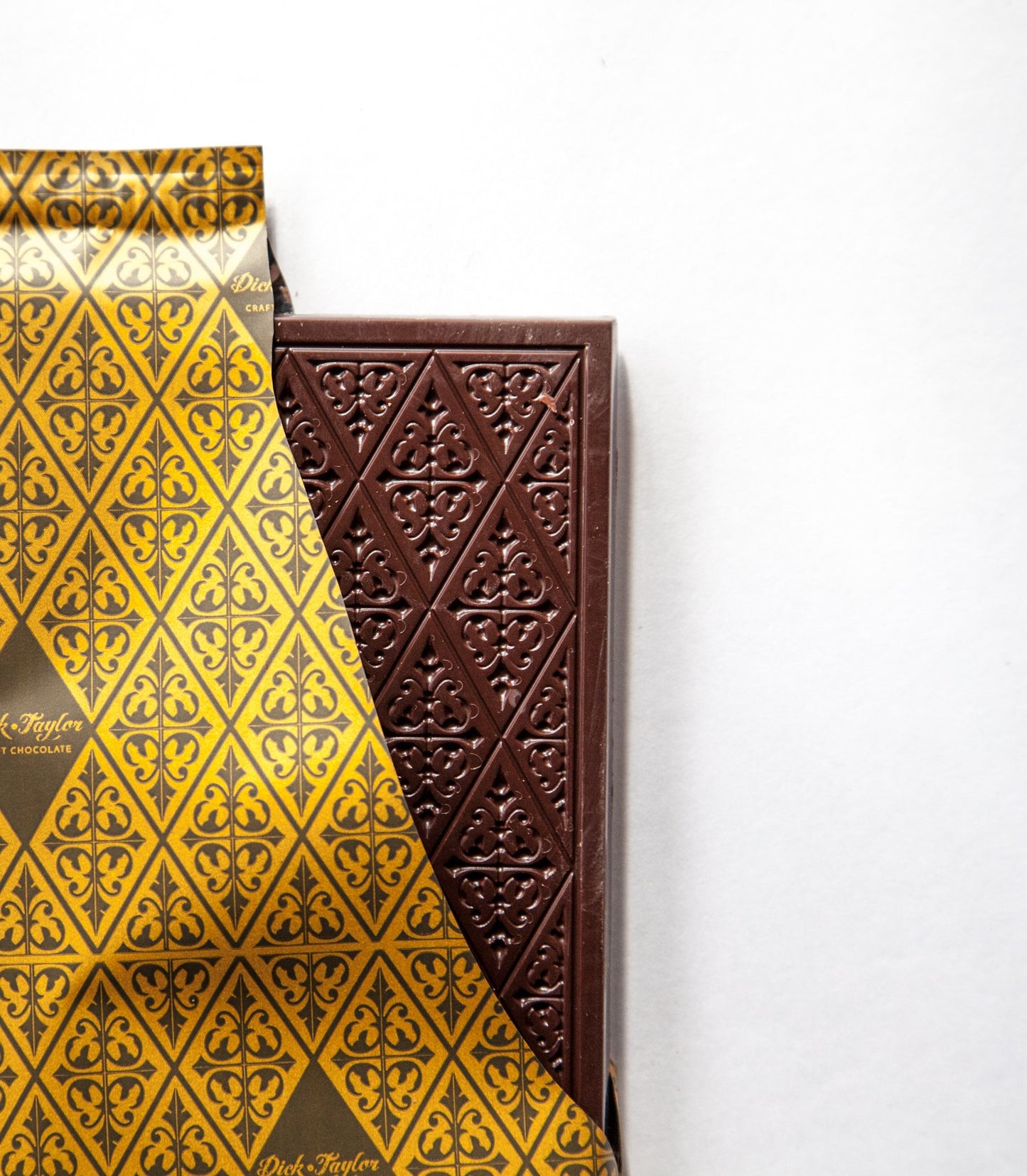 Rectangular gift box with dark brown and gold patterned chocolate slabs