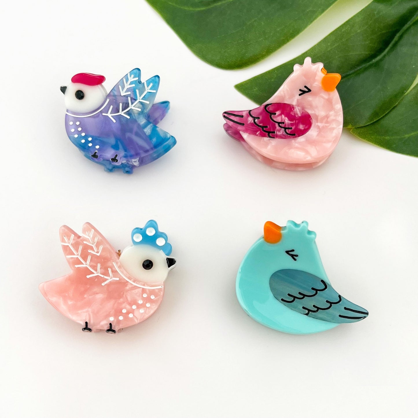 Mini bird hair claw clip set with blue, pink, purple, and turquoise designs