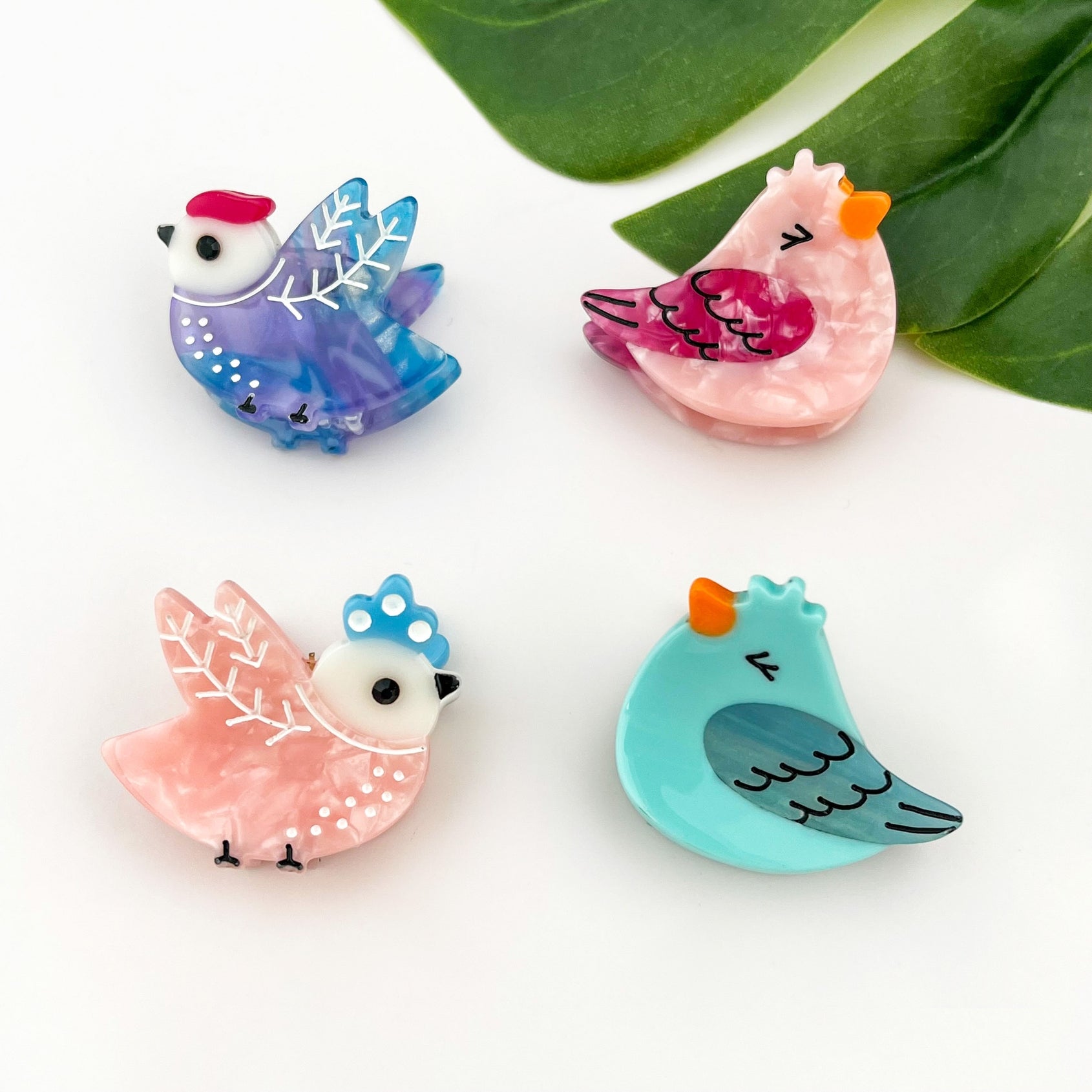Mini bird hair claw clip set with blue, pink, purple, and turquoise designs