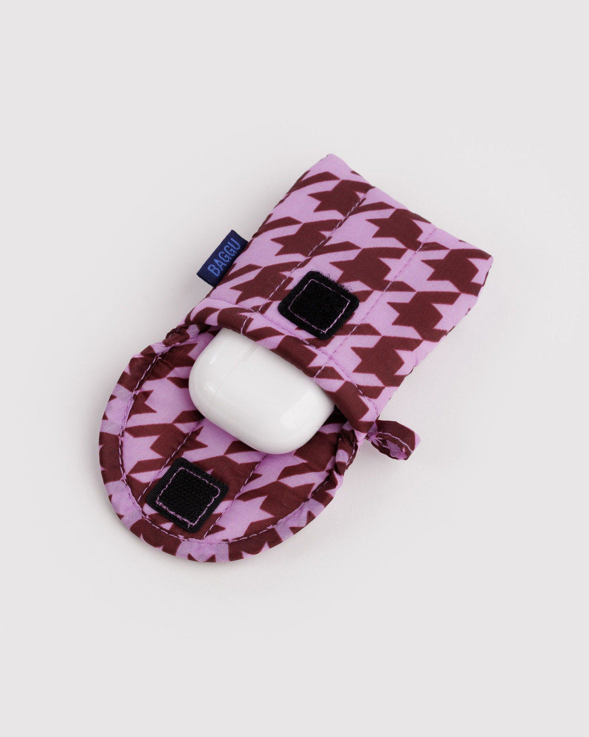 Houndstooth puffy earbuds case with earbud inside and black square accents, tied ribbon opening