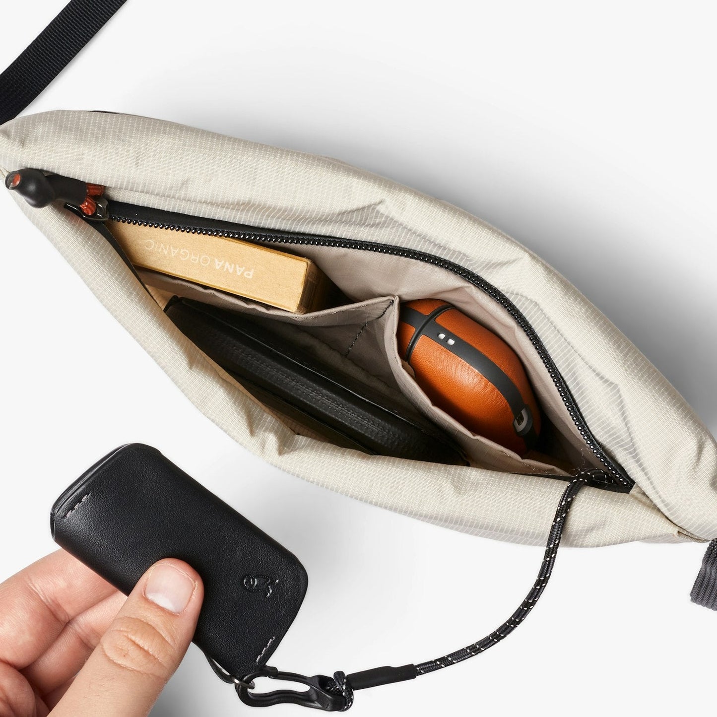 Light ash crossbody bag interior with zip pocket and card-sized phone slot, front open