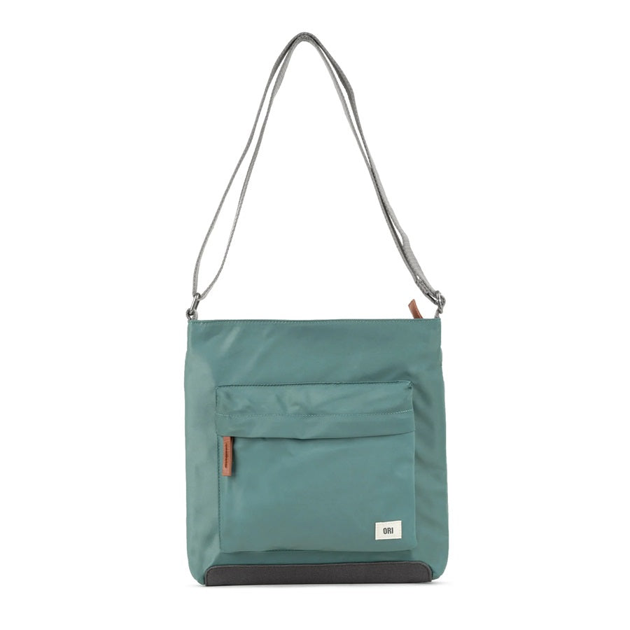 Sustainable nylon crossbody bag in dusty teal with zip front pocket