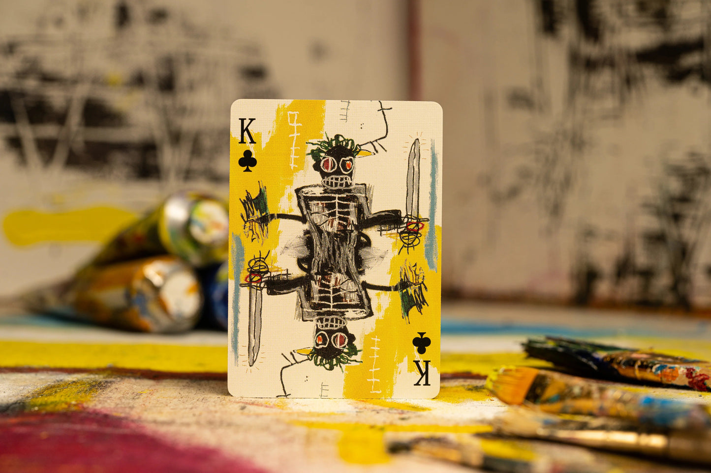 Basquiat playing card face-up with King “K” and robot-like artwork