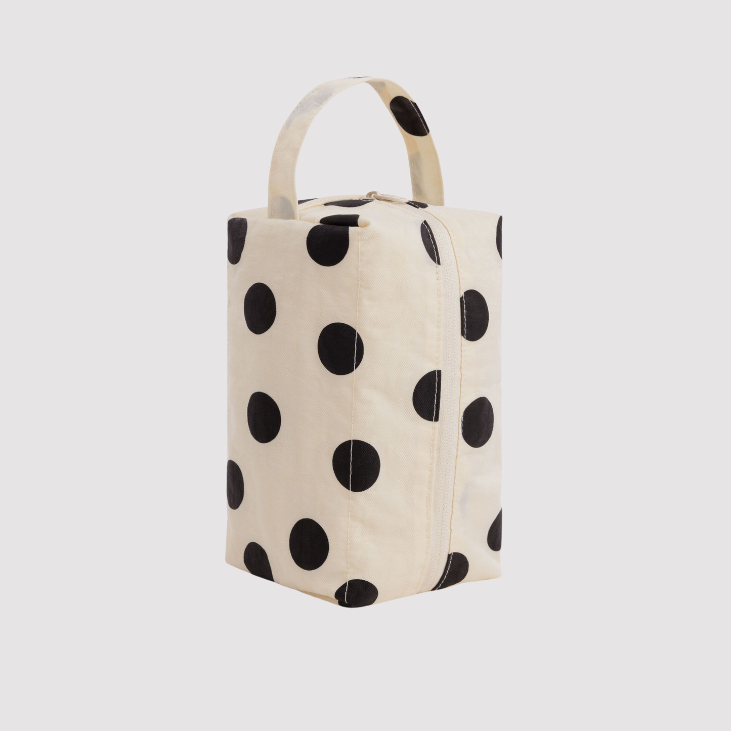 Cream dopp kit with large black polka dots, zip top and carry handle