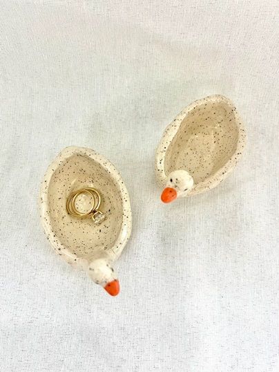 Goose-shaped ring dish pair with speckled ceramic bowls, orange beaks, brass ring holder