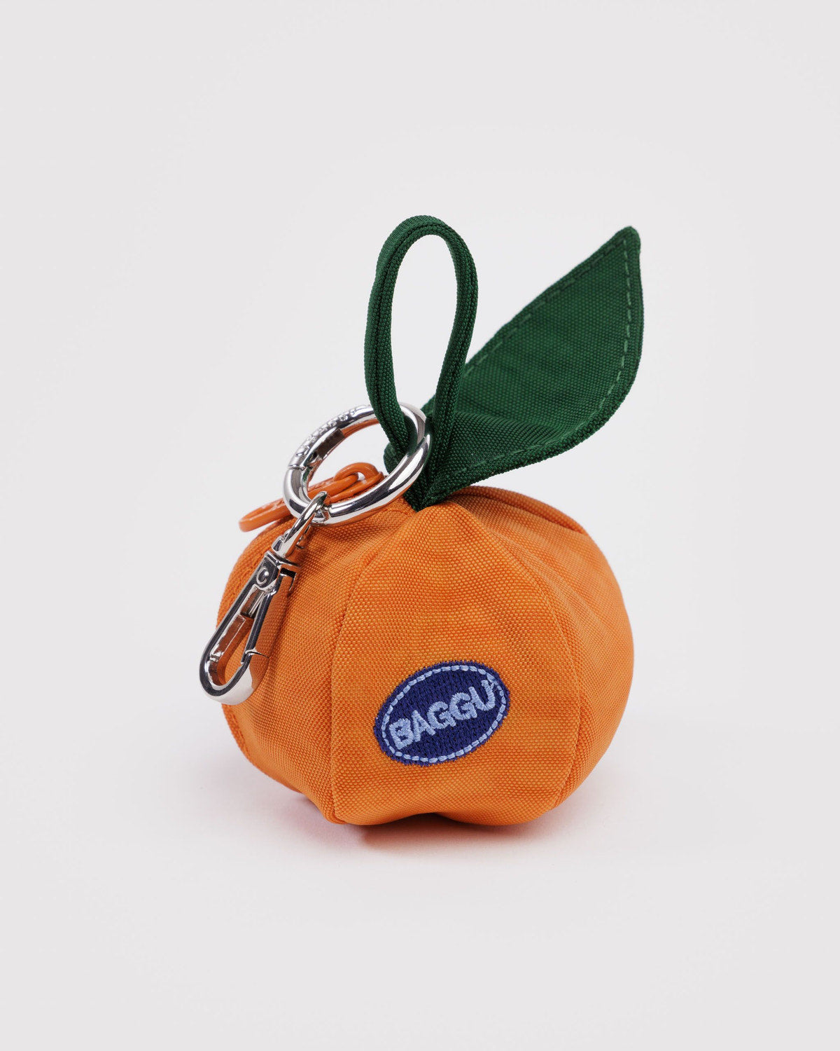 Orange pouch keychain with green leaf detail and metal clasp, BAGEGU badge