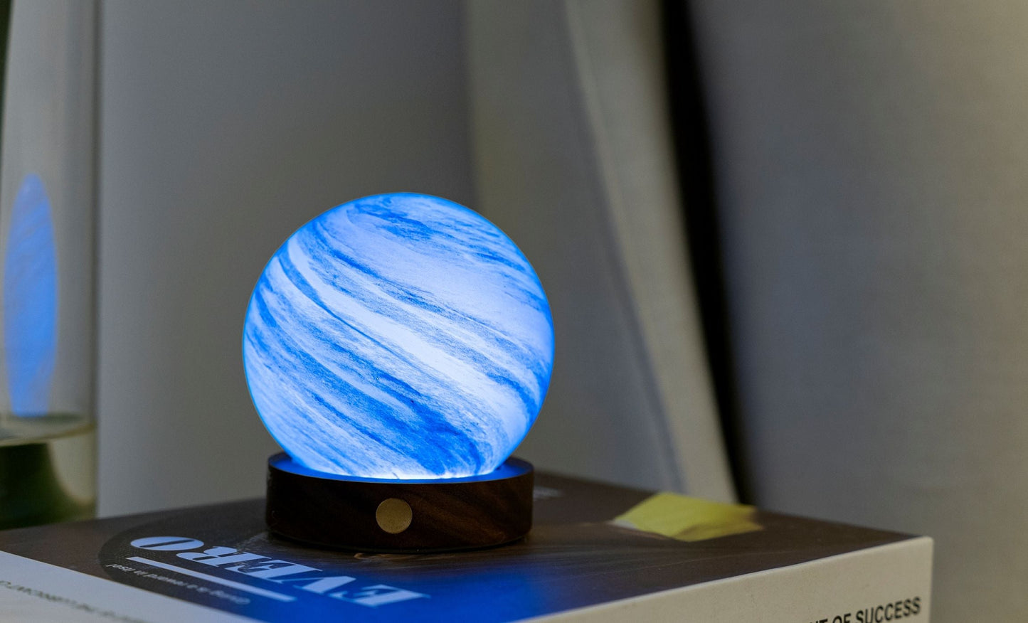 Swirling blue glass globe light on dark base