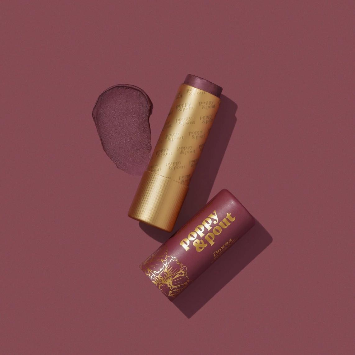 Lip tint duo with gold tube and brown-purple cap, plus lip tint package.