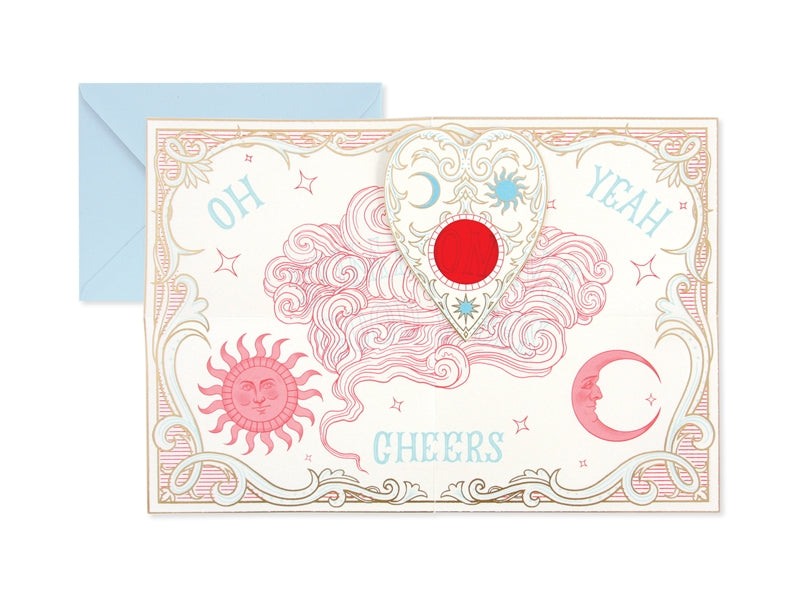 Pop-up card with red circle medallion, sun/moon symbols, ornate pink border, with envelope