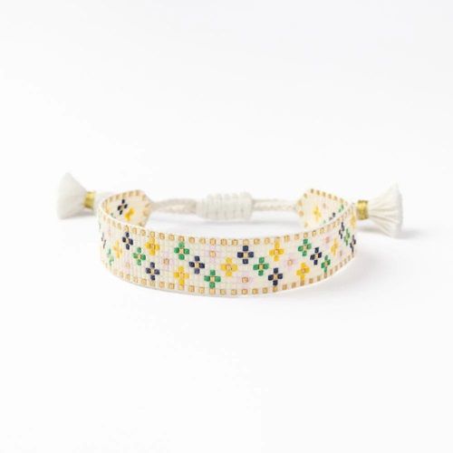Ivory beaded adjustable bracelet with multicolor floral pattern and tassel ends