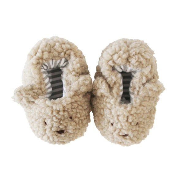 Oatmeal sherpa bear booties, fuzzy beige plush with striped lining and bear-face toe.