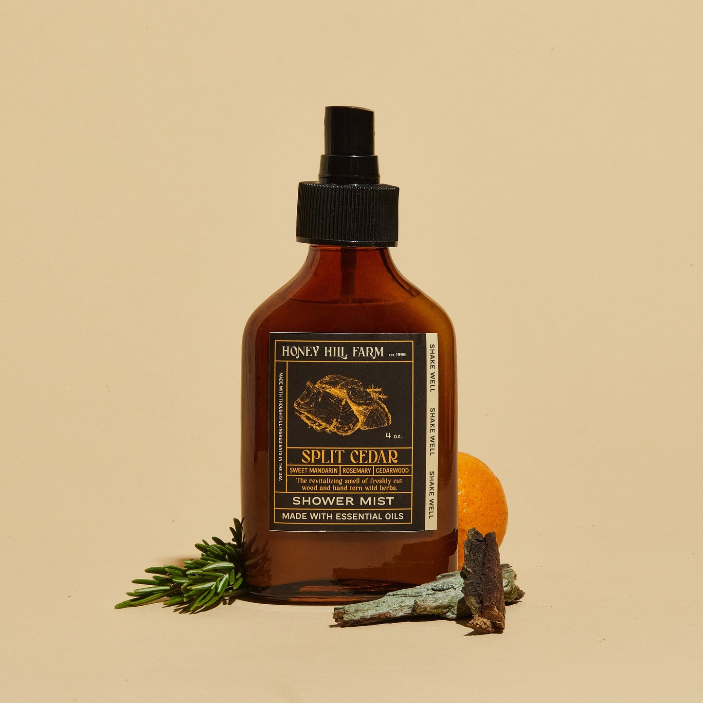 Shower mist spray bottle, amber glass and black pump; Split Cedar scent.