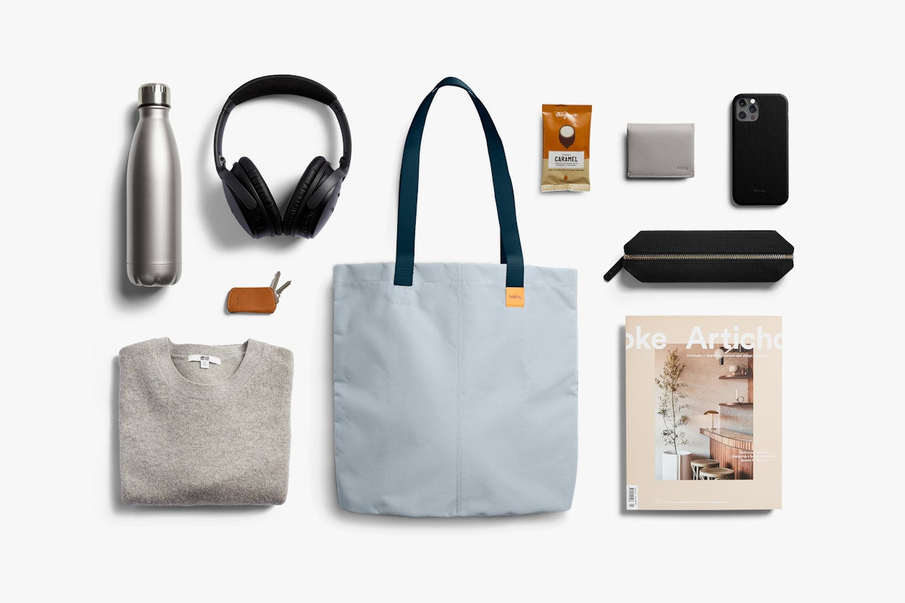 Light blue tote bag with handles, shown with everyday carry items