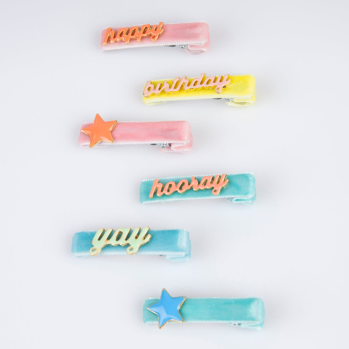 Pastel enamel hair clips with candle and star shapes and 'birthday' lettering on bars